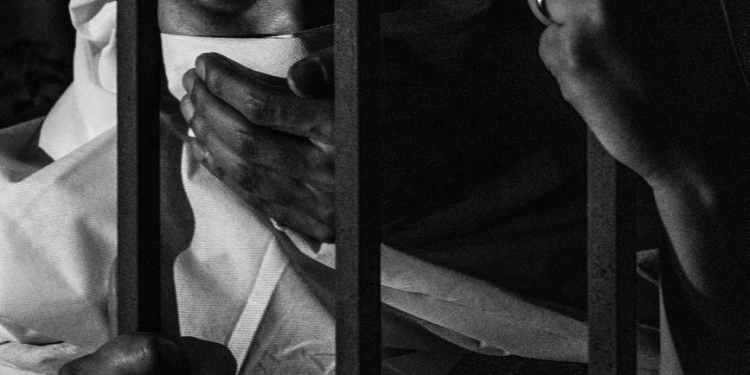 grayscale photography of woman inside jail